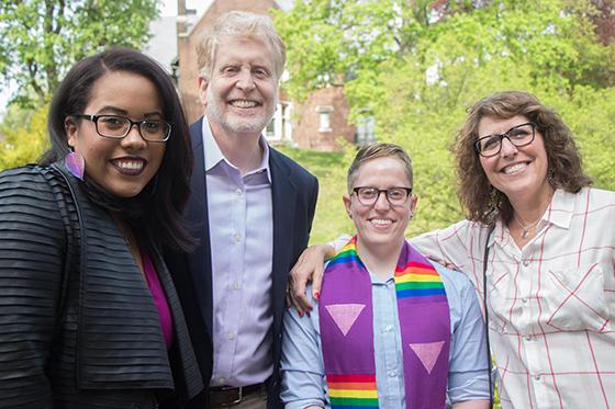 Photo of a smiling group of people at Lavender Graduation